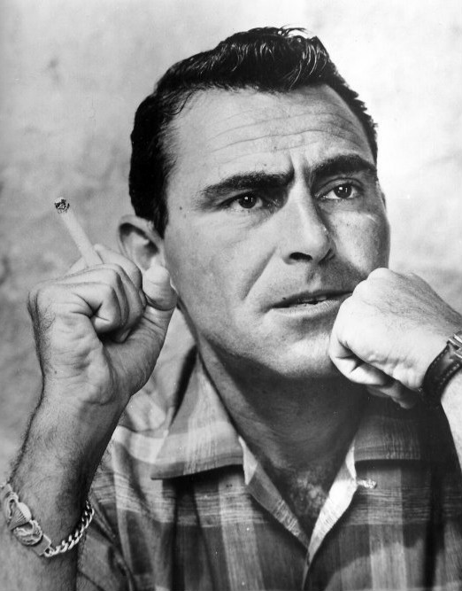 Black and white portrait of Rod Serling resting his chin on one fist and holding a cigarette in the other hand